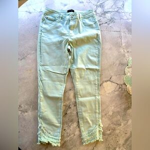 Light blue denim jeans with ruffle ankle design.